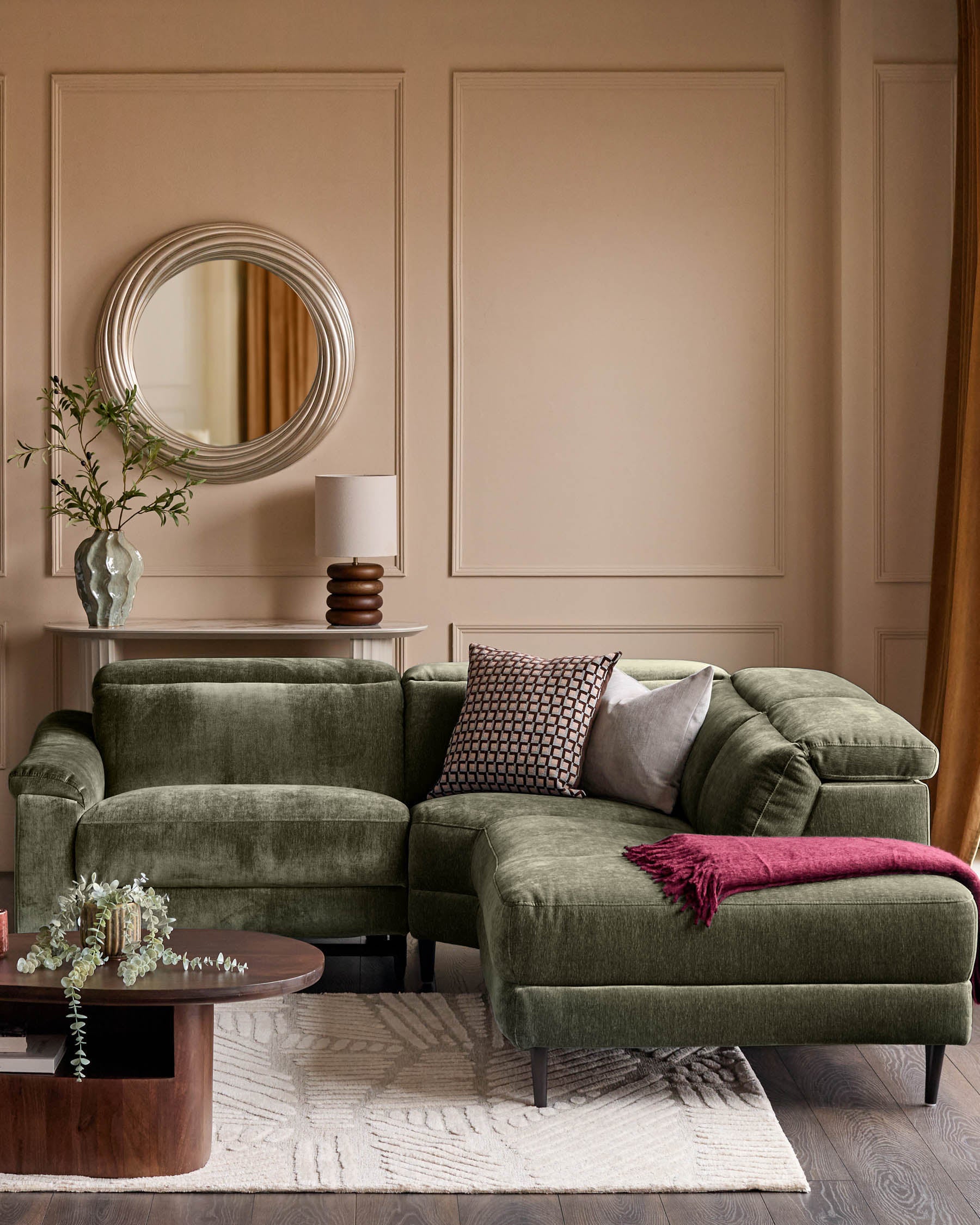 Dark green fabric right-hand corner recliner sofa with rolled arms, displayed in a contemporary living room setting with accent pillows and throw blanket.