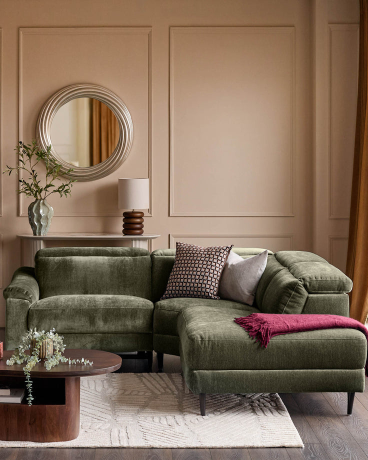 Dark green fabric right-hand corner recliner sofa with rolled arms, displayed in a contemporary living room setting with accent pillows and throw blanket.