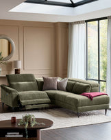 Serene right small corner recliner sofa in dark green fabric with one reclining seat extended, positioned in a bright living room with skylight.