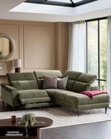 Serene right small corner recliner sofa in dark green fabric with reclined left seat, positioned in a bright living room with skylight.