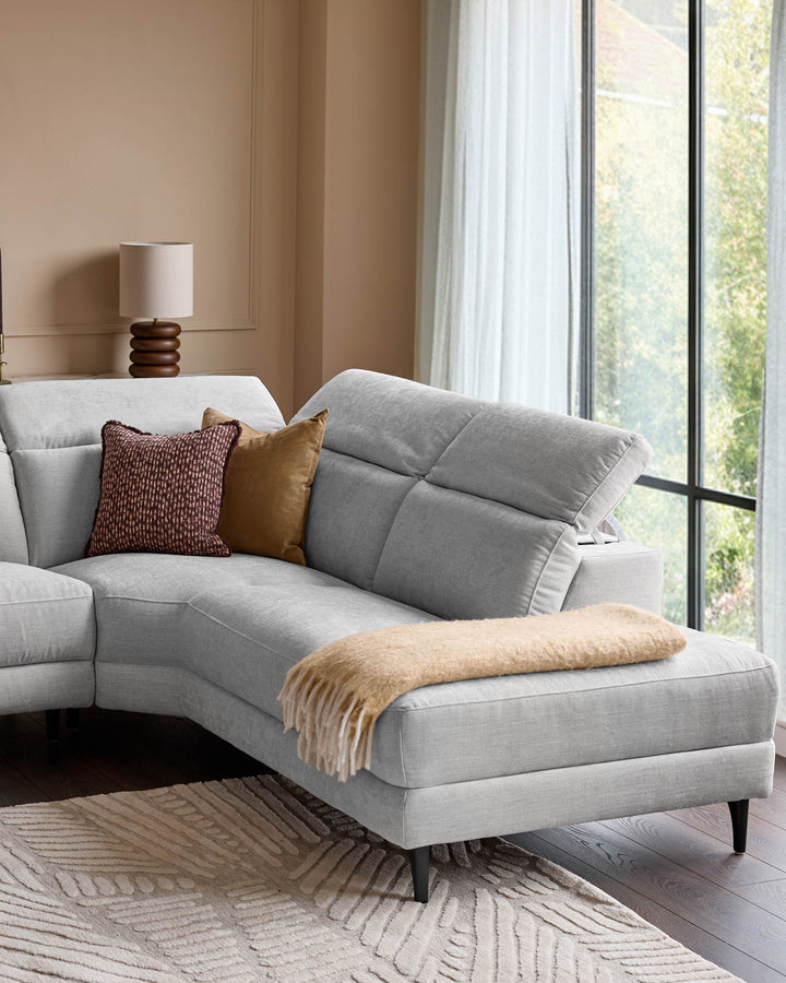 Light grey fabric right-corner recliner sofa with black legs, styled with burgundy and gold pillows and a beige throw blanket.