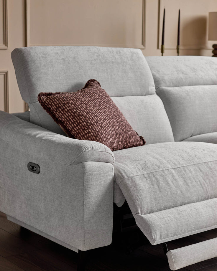 Light grey fabric right-hand recliner sofa with footrest extended, burgundy cushion, control button visible on armrest.