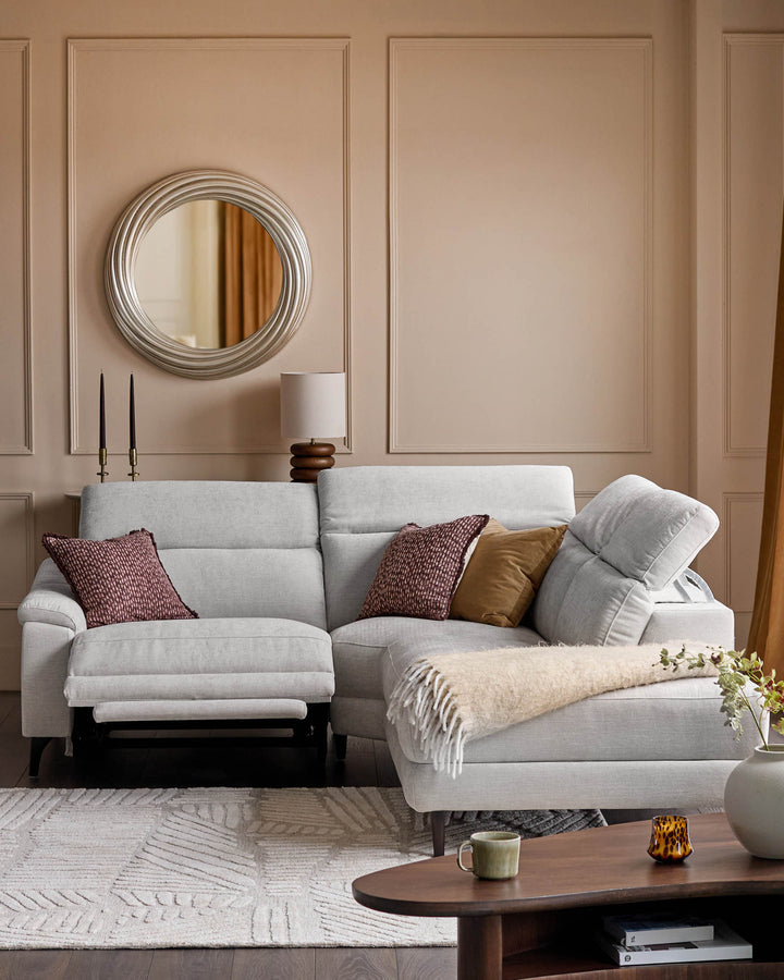 Serene right small corner recliner sofa in light grey fabric, styled in a warm neutral living room with decorative pillows and throws.