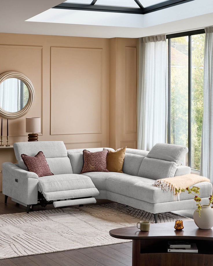 Light grey fabric right-hand corner recliner sofa with extended footrest, displayed in a modern living room setting.