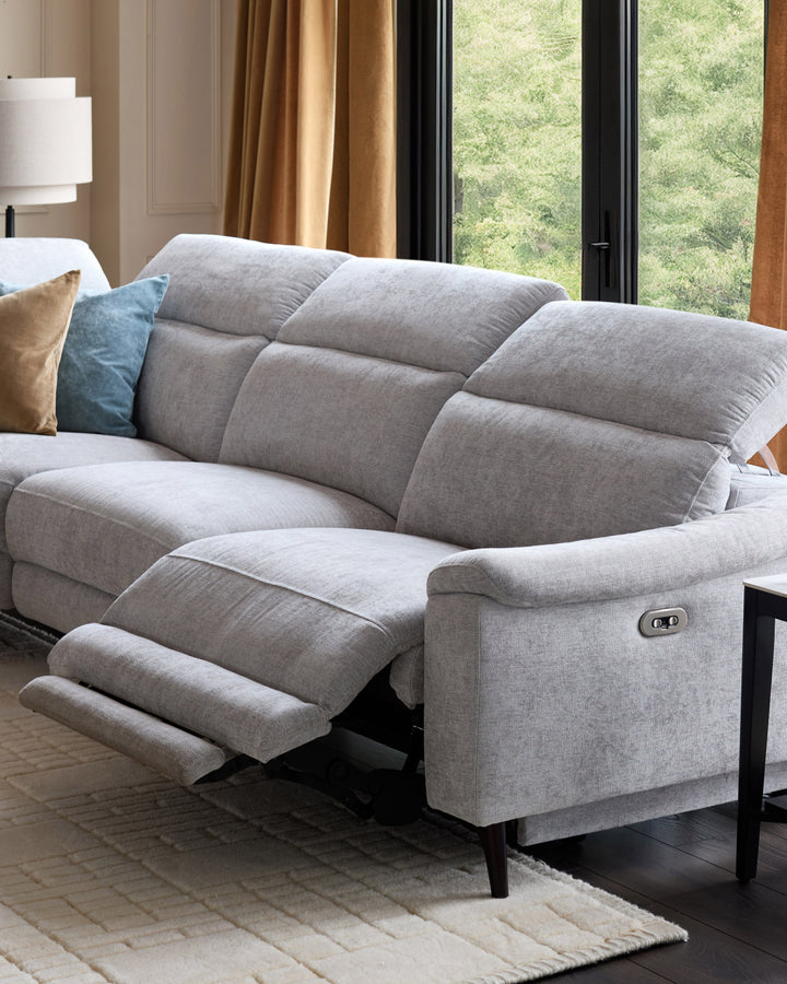 Serene left chaise recliner sofa in light grey chenille with footrest extended, shown in modern living room setting.