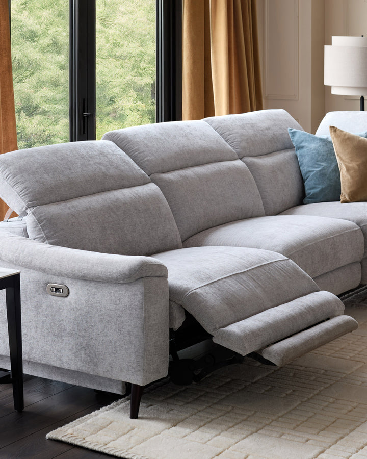 Light grey chenille right chaise recliner sofa with extended footrest, shown in a modern living room setting.