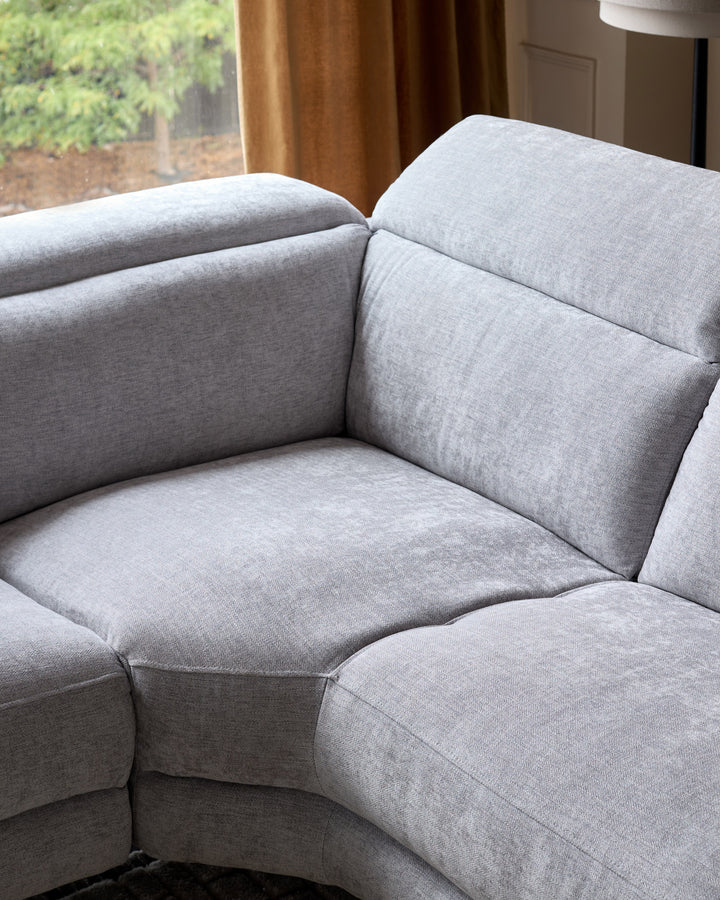 Serene left chaise recliner sofa in light grey chenille, showing curved sectional design with plush cushioned seating.