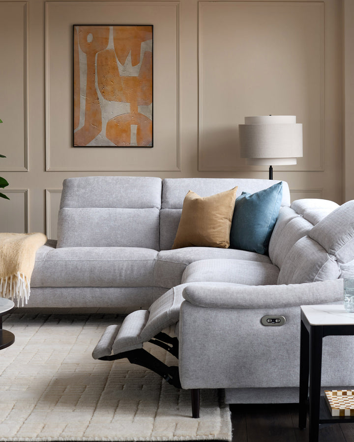 Serene left chaise recliner sofa in light grey chenille with footrest extended, shown in modern living room setting.
