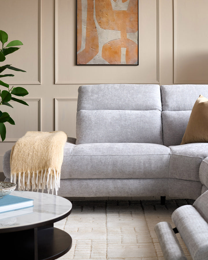 Serene Left Chaise Recliner Sofa in light grey chenille, shown in a styled living room setting.