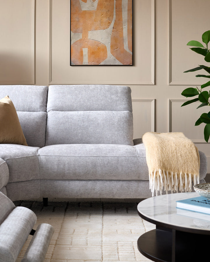 Light grey chenille right chaise recliner sofa with cushioned back and seat, displayed in a modern living room setting.