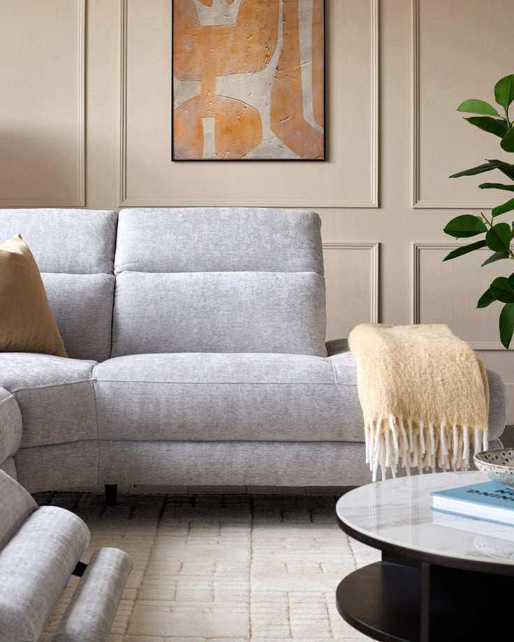 Light grey chenille right chaise recliner sofa with cushioned back and seat, displayed in a modern living room setting.