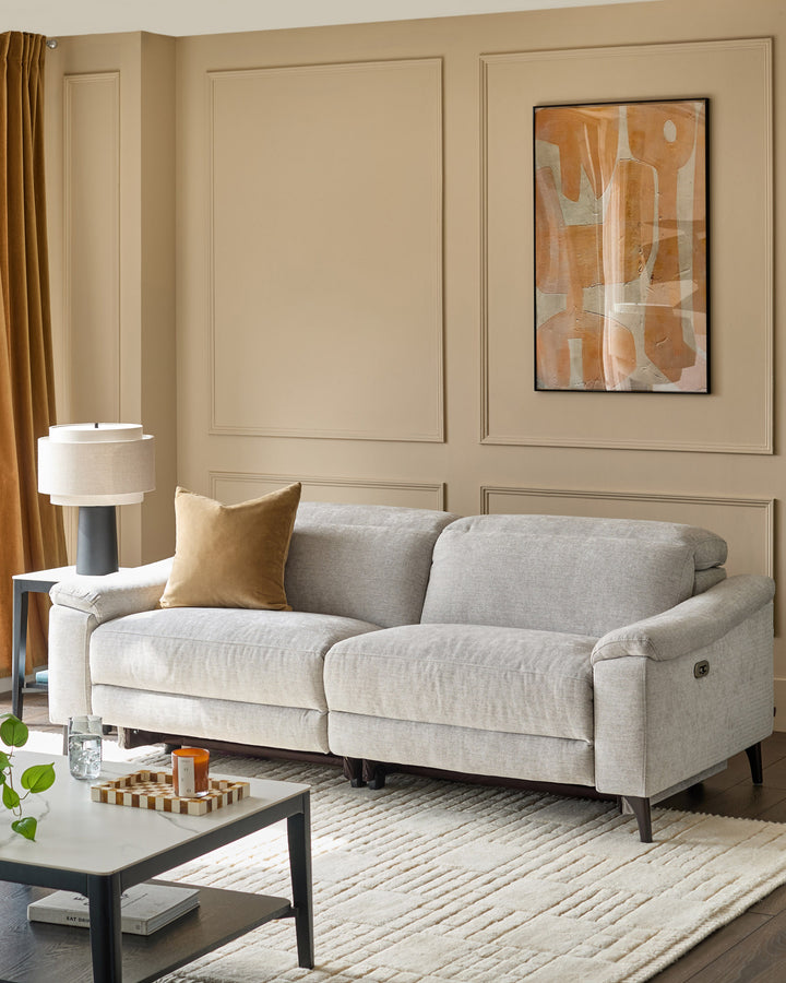 Serene 3-seater light grey fabric recliner sofa with rolled arms and tapered legs in a contemporary living room setting.