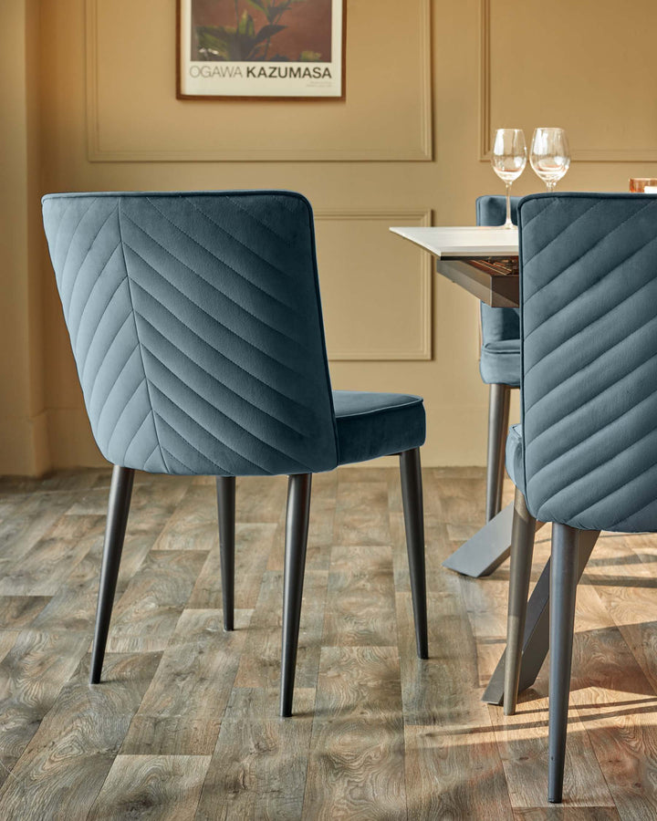 A stylish dining setting, featuring upholstered chairs with dark legs, paired with a modern white-topped table.