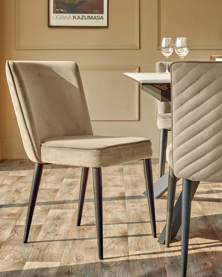 A stylish dining set featuring upholstered chairs with dark legs and a modern table. Elegant design for a contemporary dining space.
