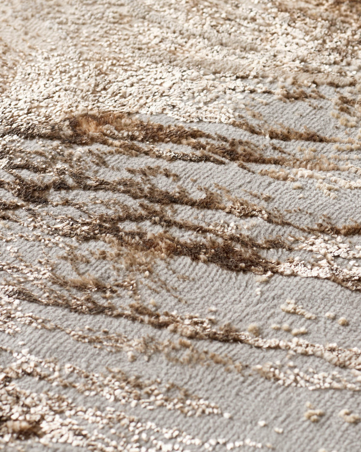 Close-up of a textured carpet featuring a blend of neutral tones and raised, patterned detailing. Ideal for adding warmth.