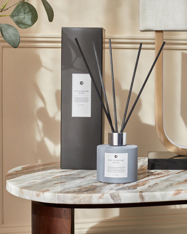 Elegant reed diffuser set on a marble table, featuring a sleek design and calming fragrance for a cosy home ambiance.