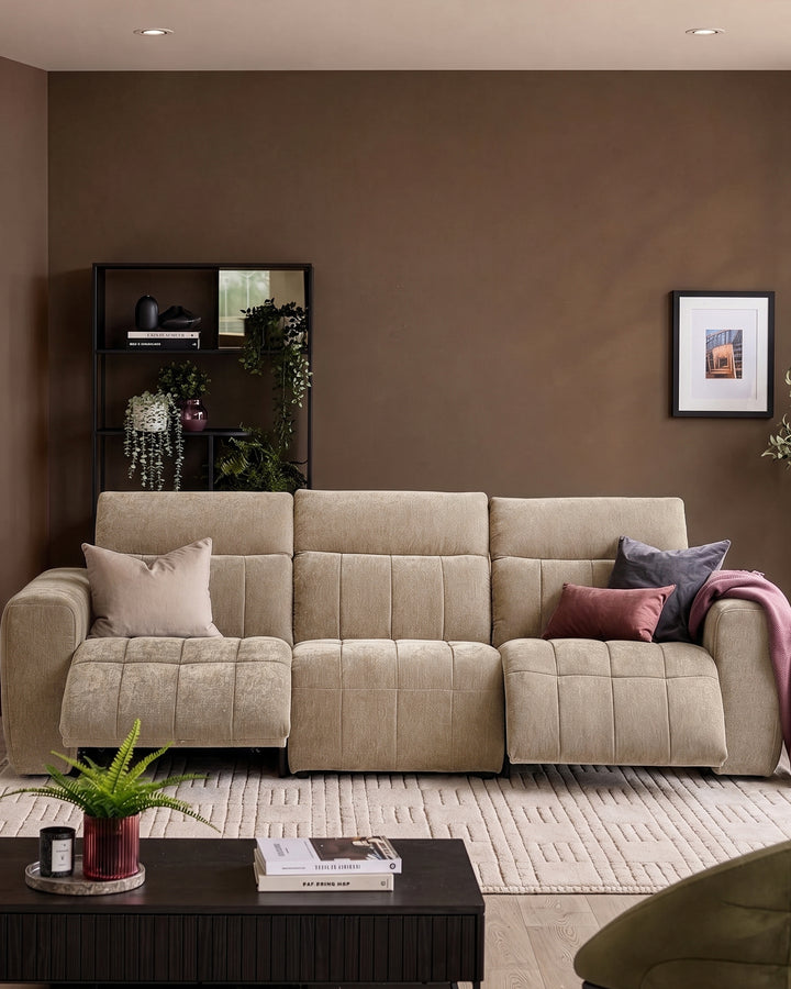 Champagne fabric 3-seater sofa with quilted seats and rolled arms in a styled living room setting.
