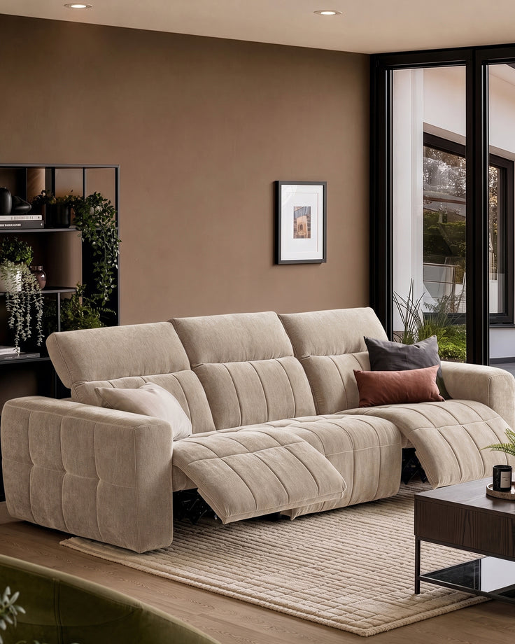 Skye 3-seater sofa in champagne fabric with quilted design, shown in a modern living room with recliners extended.
