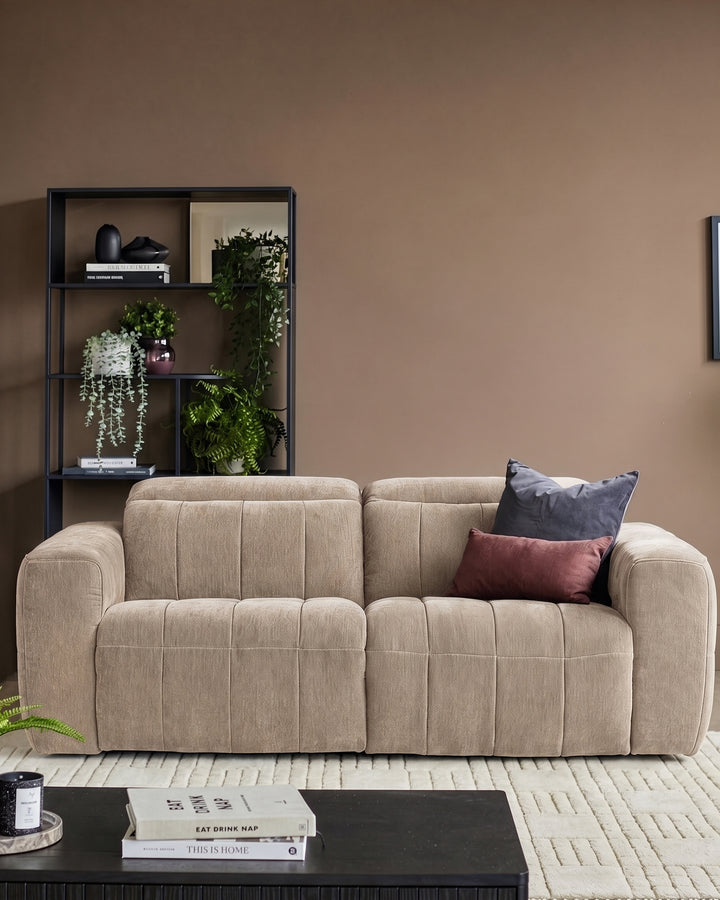 Champagne fabric 2-seater sofa with quilted detailing and rounded arms, styled in a living room setting.