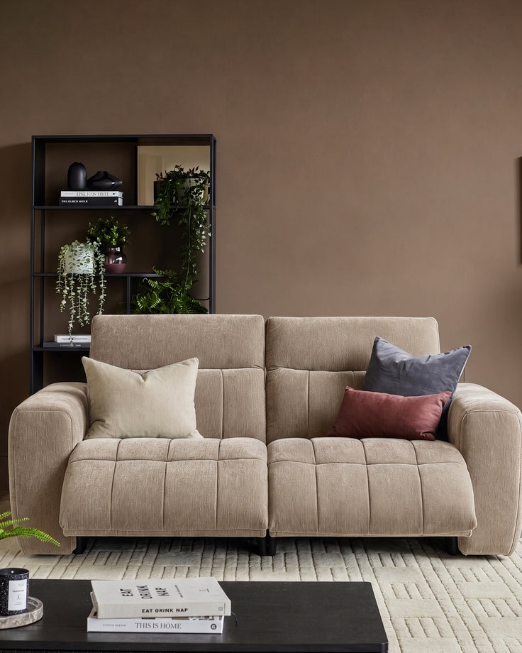 Champagne Skye 2-seater sofa with quilted seat cushions, rounded arms, and matching throw pillows in a styled living room setting.