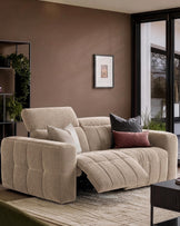 Skye 2-seater sofa in champagne fabric with quilted seat, shown in a modern living room with accent pillows.