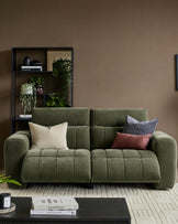 Skye 2-seater sofa in dark green fabric with quilted seat cushions, rounded arms, and black legs, styled in a living room setting.