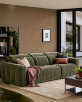Skye 3-seater sofa in dark green ribbed fabric, displayed in a modern living room with neutral walls and large windows.
