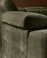 Skye 2-seater sofa in dark green fabric, close-up detail of padded armrest and side panel.