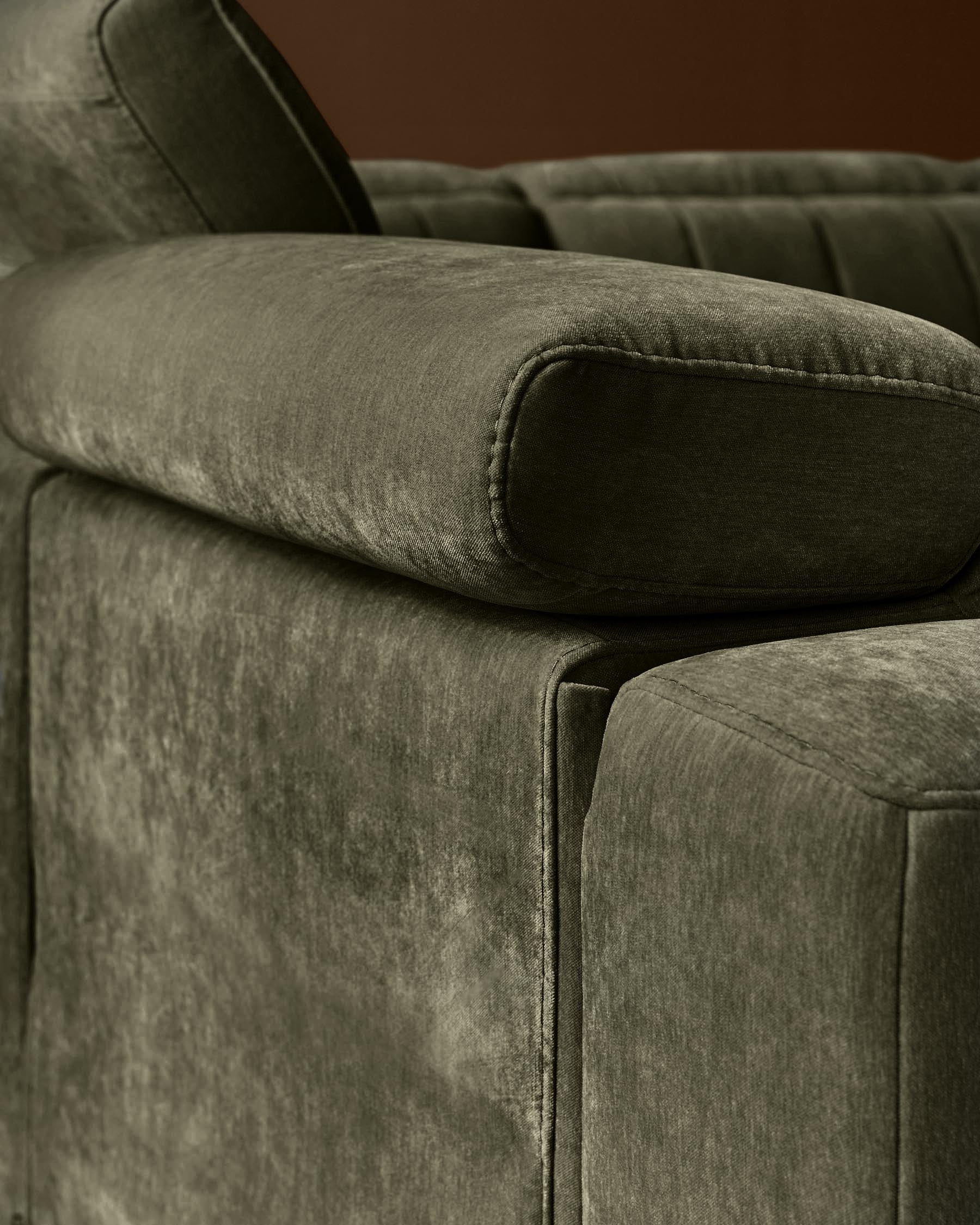 Skye 2-seater sofa in dark green fabric, close-up detail of padded armrest and side panel.