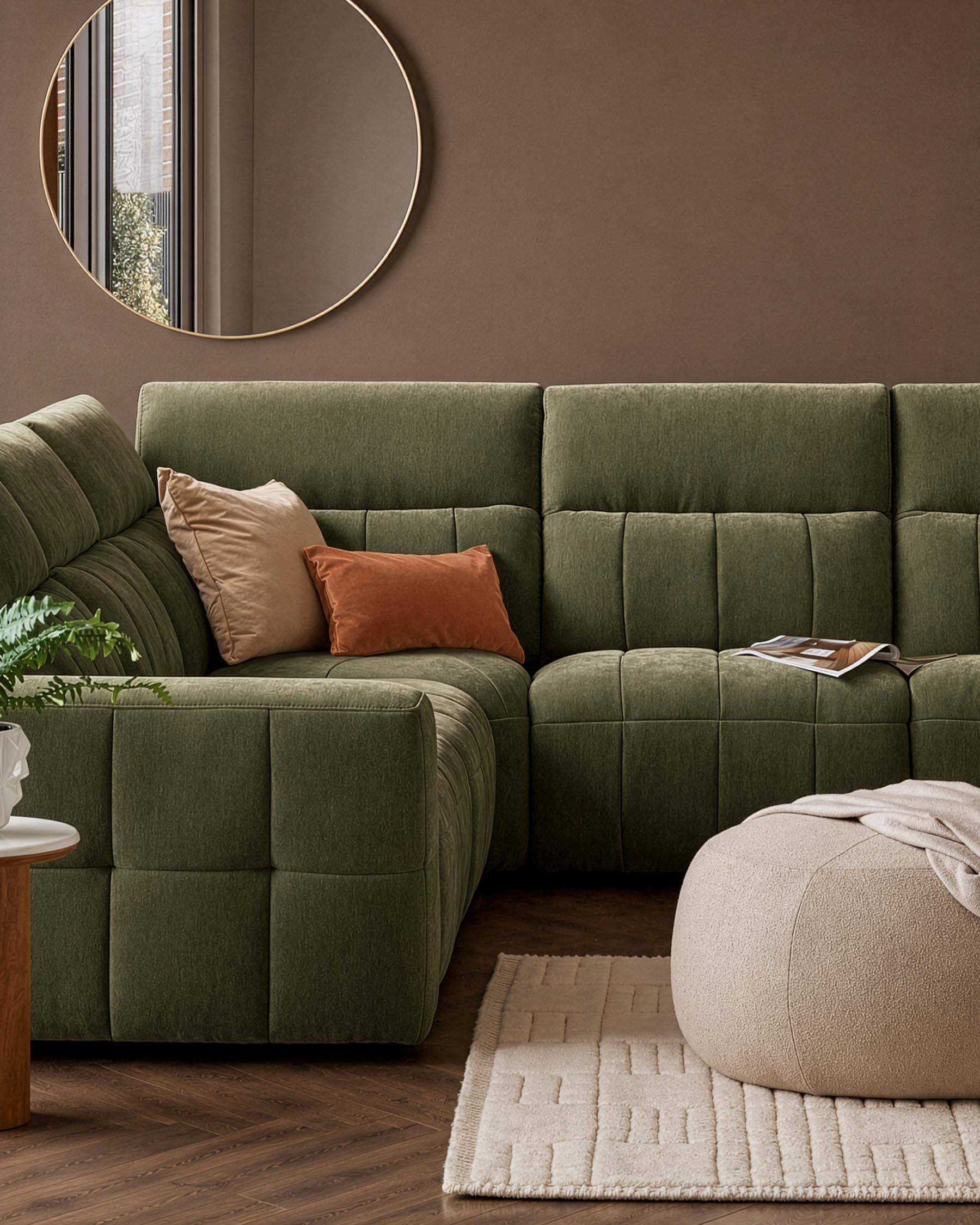 Skye large corner sofa in dark green fabric with quilted design, styled with cushions in a warm living room setting.