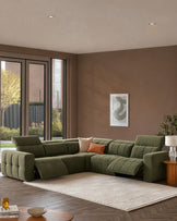 Skye large corner sofa in dark green fabric with reclining sections, displayed in a modern living room with taupe walls.