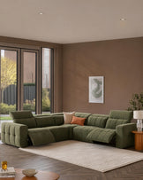 Olive green fabric reclining corner sofa module with quilted detailing in modern living room setting.