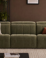 Skye single sofa module in dark green fabric with quilted channel detailing, shown as part of a modular sectional arrangement.