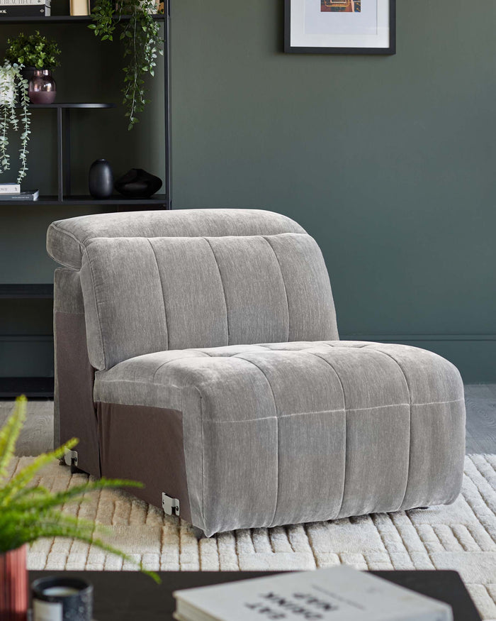 A stylish, grey, single-seater sofa bed on a cream textured rug, perfect for a contemporary living space.