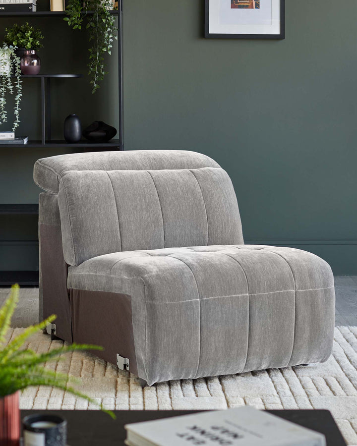 A stylish, grey, single-seater sofa bed on a cream textured rug, perfect for a contemporary living space.