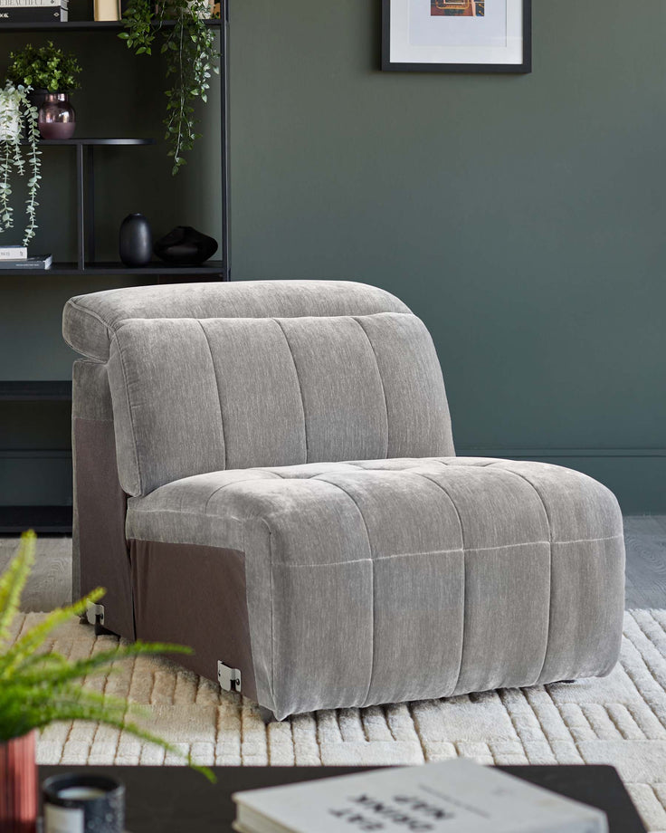 A stylish, grey, single-seater sofa bed on a cream textured rug, perfect for a contemporary living space.