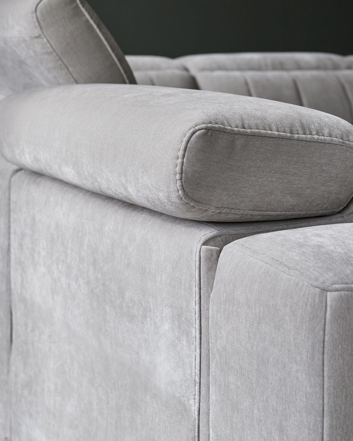 Modern grey velvet sofa featuring plush, rounded cushions and clean lines, ideal for stylish and comfortable living spaces.