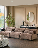 Sofia 3-seater sofa in mocha fabric with cylindrical bolster cushions, displayed in a modern living room setting.