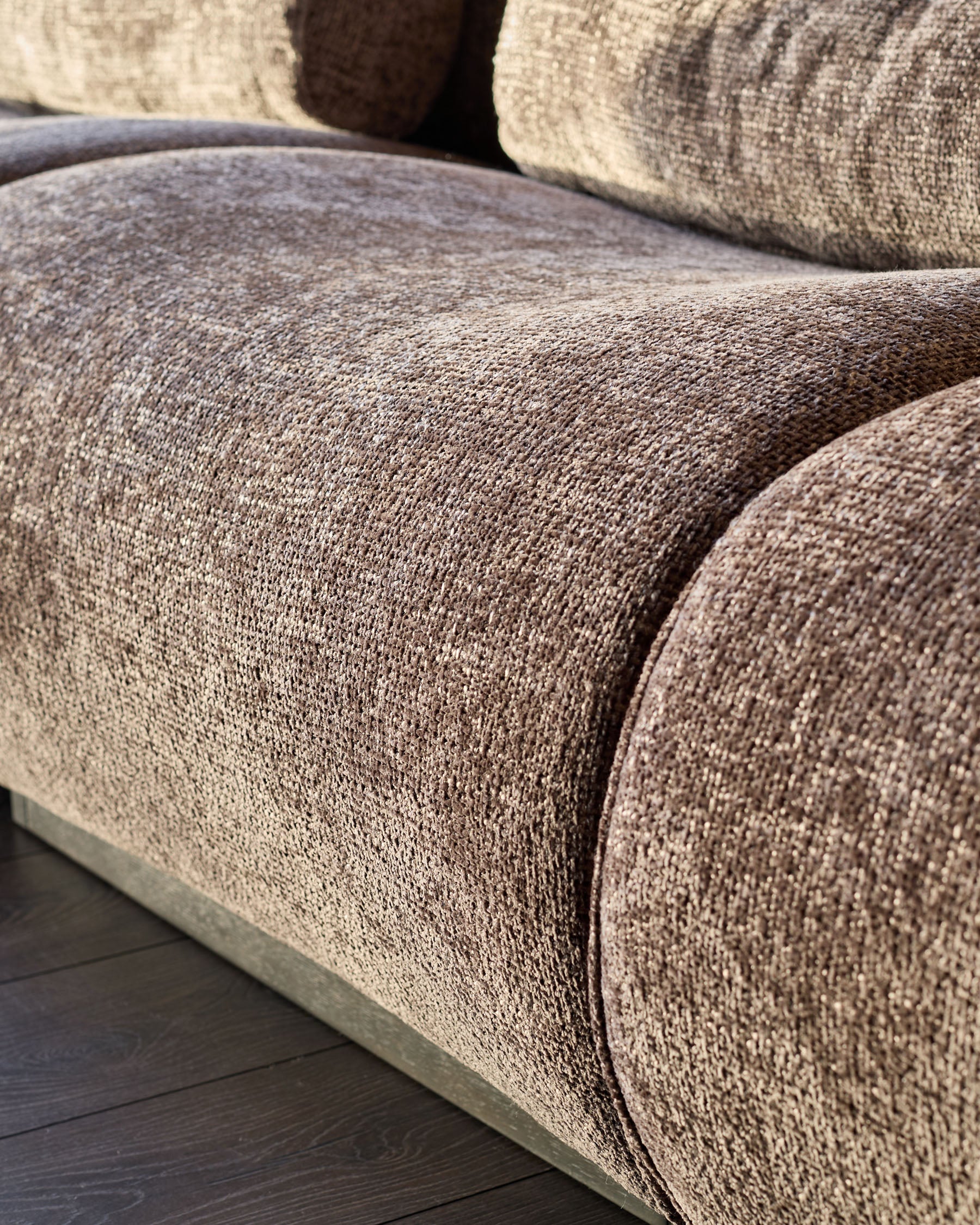 Sofia 3-seater sofa in mocha fabric, close-up detail showing textured weave and curved armrest design.