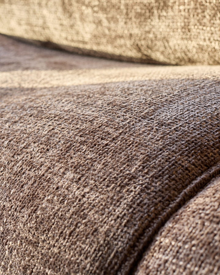 Close-up of mocha fabric texture on Sofia 2-seater sofa, showing woven weave detail and seam.
