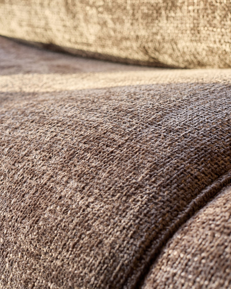 Close-up of mocha fabric texture on Sofia 2-seater sofa, showing woven weave detail and seam.