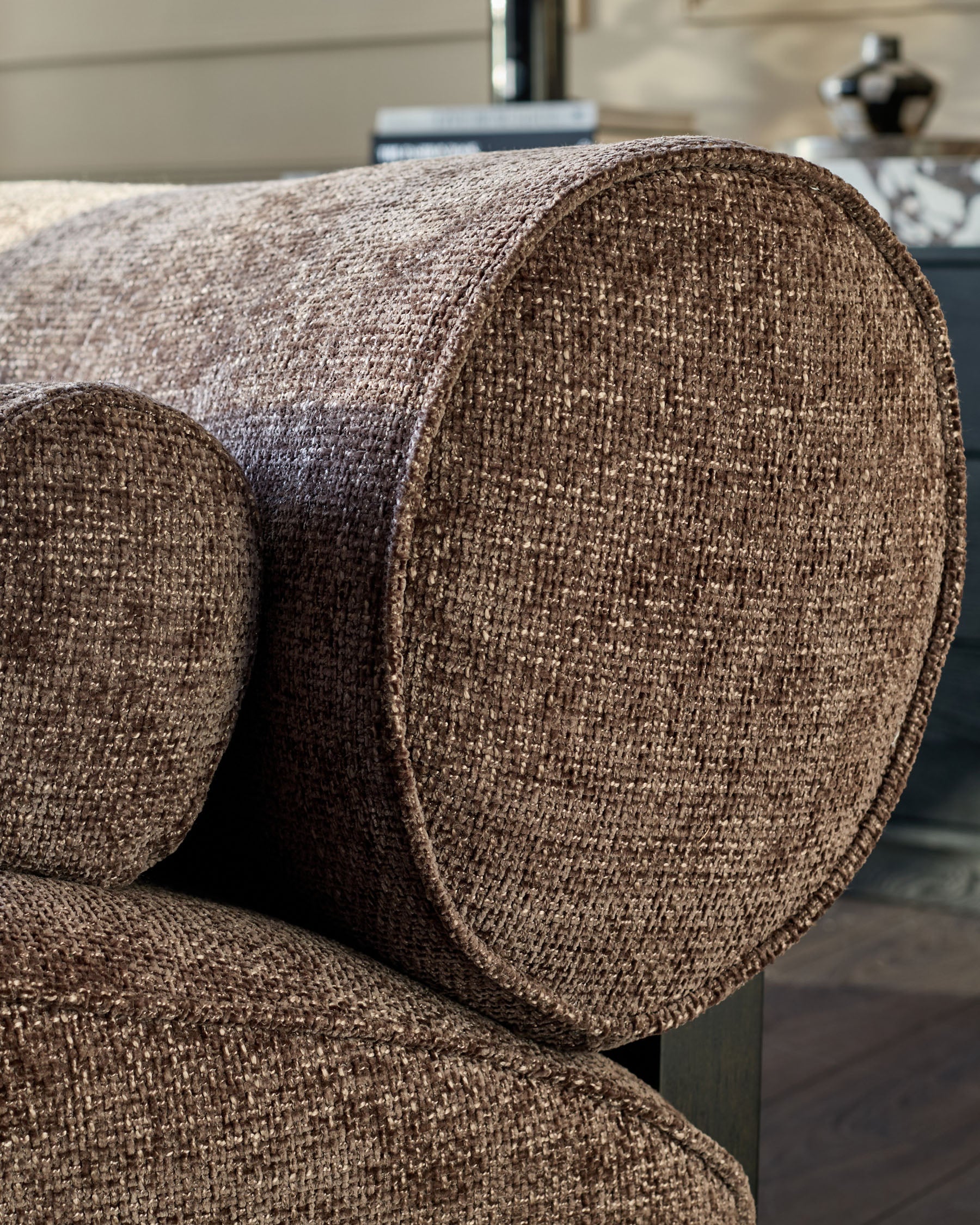 Sofia 3-seater sofa in mocha fabric, close-up detail of curved armrest and woven texture.