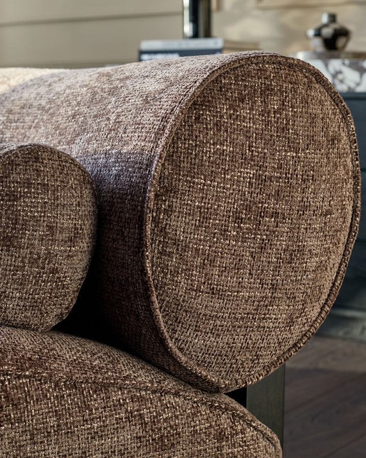 Sofia 2-seater sofa in mocha fabric, close-up detail showing textured weave and curved armrest design.
