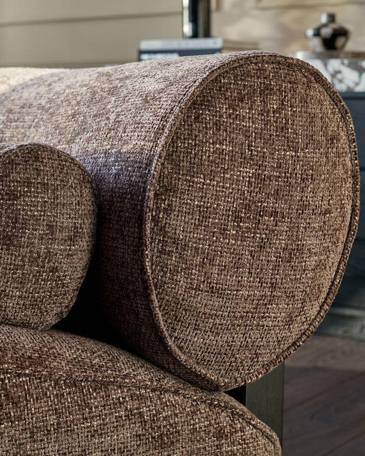 Sofia 2-seater sofa in mocha fabric, close-up detail showing textured weave and curved armrest design.