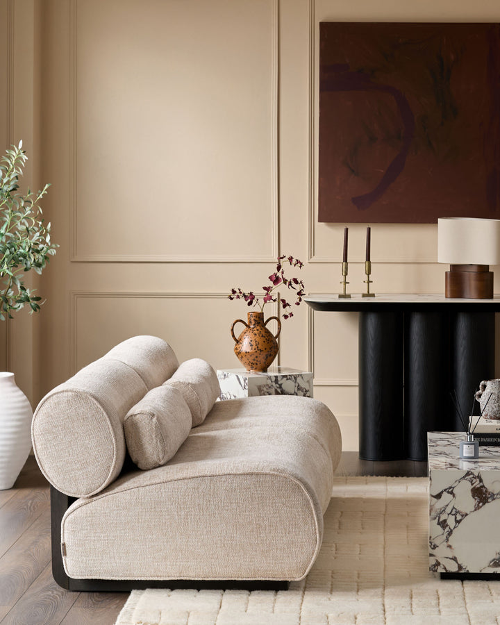 Sofia 2-seater sofa in natural fabric with curved cylindrical armrests and rounded form, styled in contemporary living room.