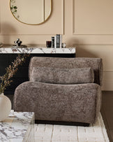Sofia accent chair in mocha fabric, shown in a styled living room setting with marble surfaces and neutral decor.