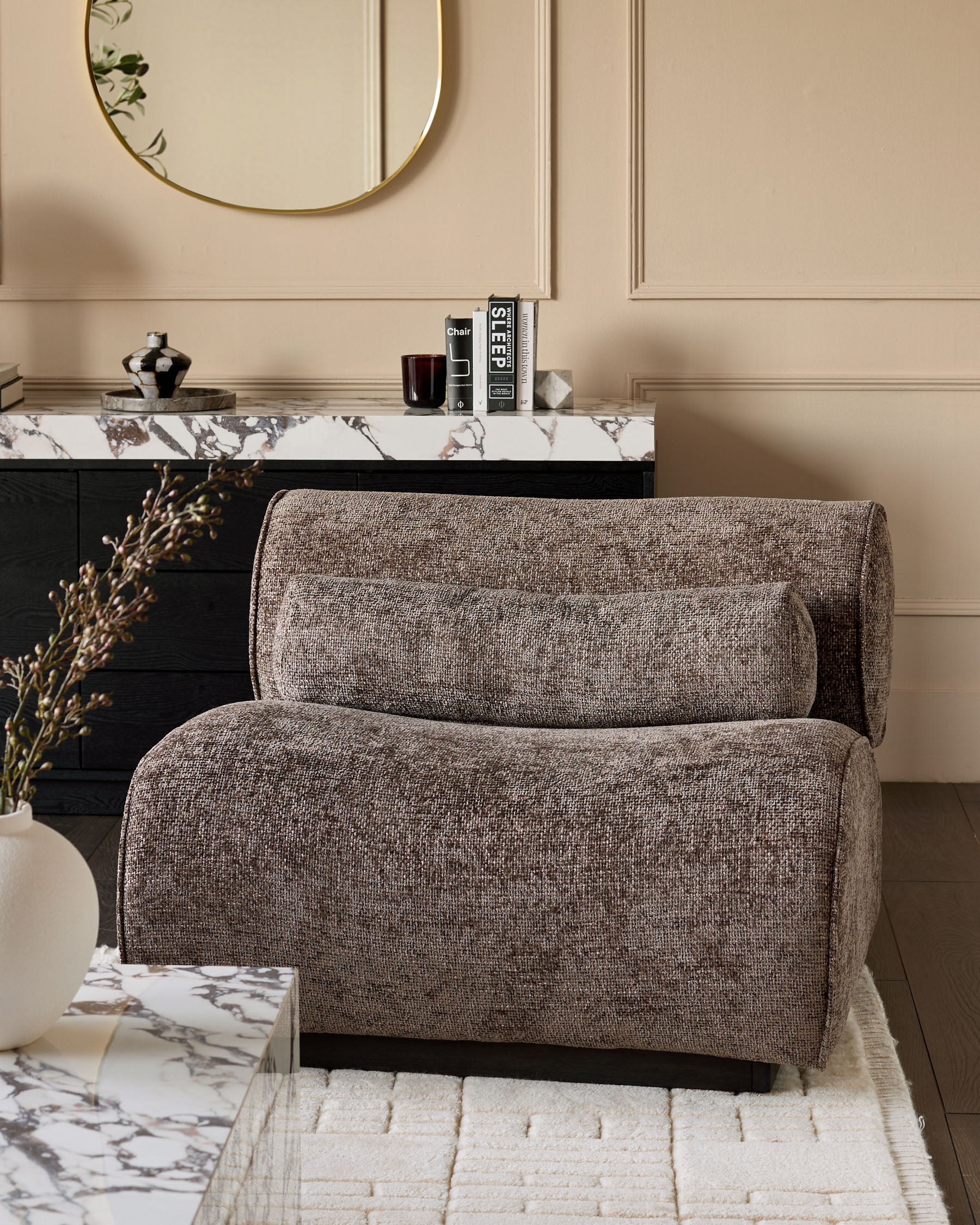 Sofia accent chair in mocha fabric, shown in a styled living room setting with marble surfaces and neutral decor.