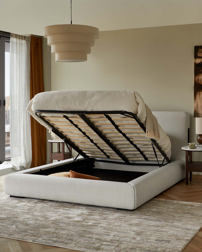 Upholstered ottoman bed with an elevated mattress, shown with the base lifted to reveal storage.