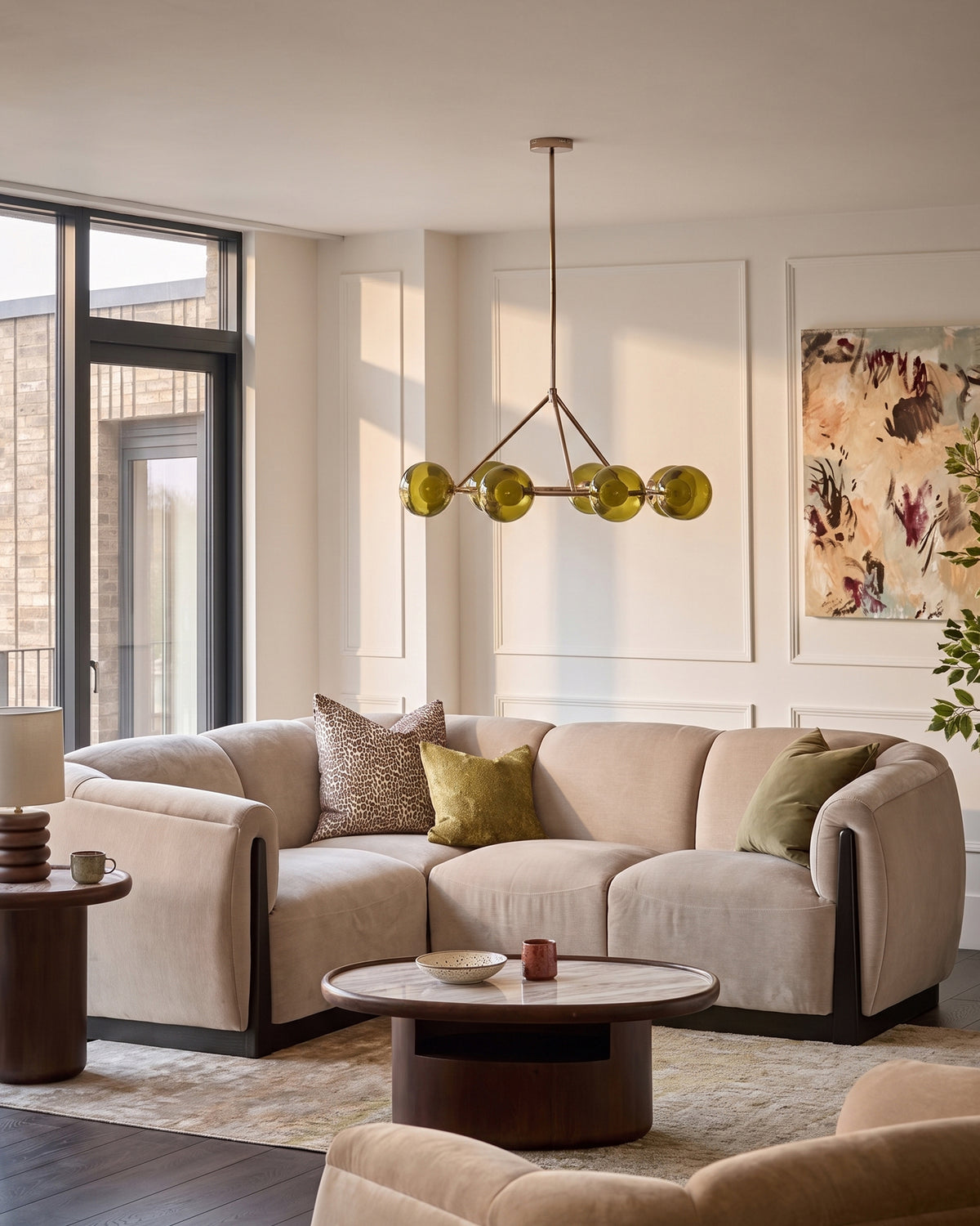Teagan left-hand small corner sofa in champagne fabric, shown in a styled living room setting with coordinating cushions and pendant lighting.