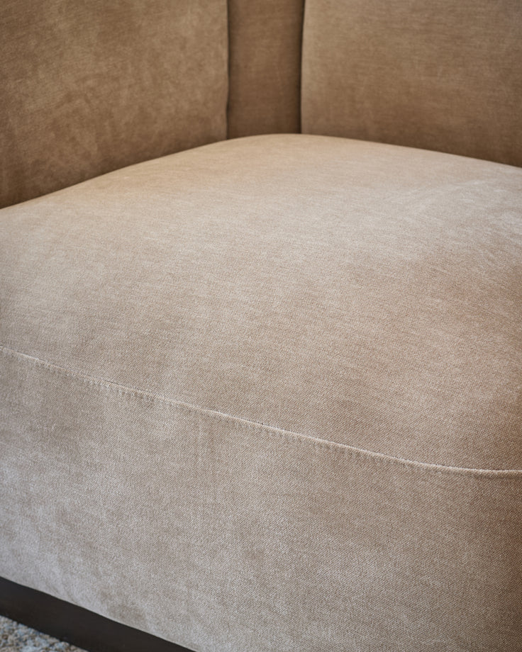 Teagan left-hand small corner sofa in champagne fabric, showing curved seat detail and upholstered back.